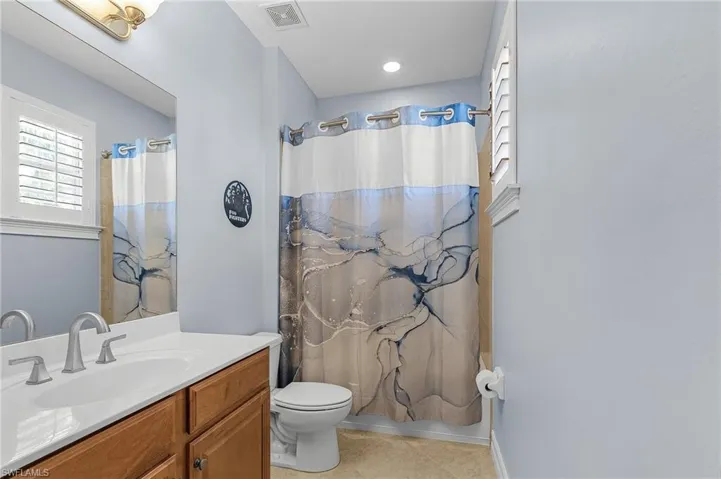 Full bath featuring vanity, tile patterned floors, and shower / tub combo
