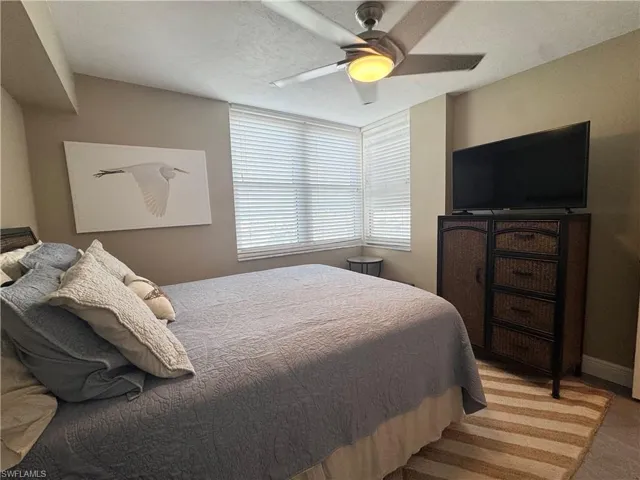 Bedroom featuring tile , queen bedroom and a ceiling fan