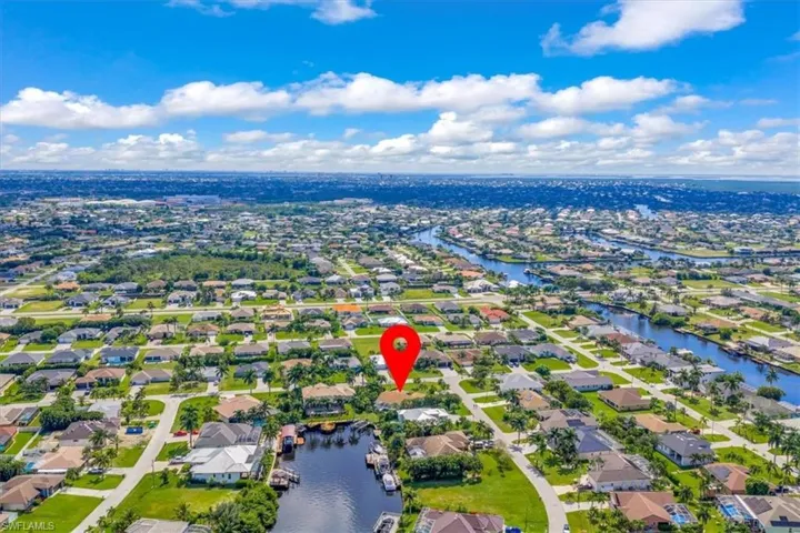 Aerial overview of property's location featuring nearby suburban area and a nearby body of water