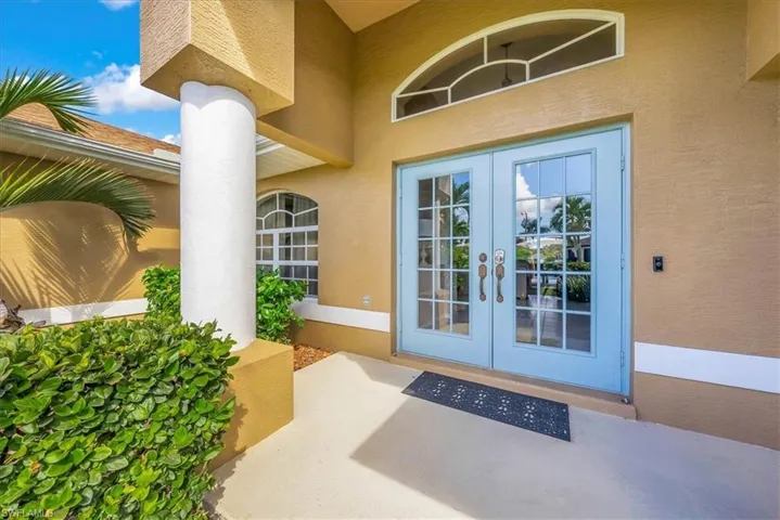 Property entrance featuring stucco siding, french doors, and a patio area