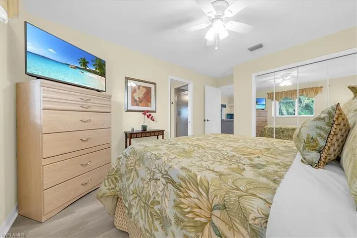 Bedroom featuring a closet, light wood-style flooring, and a ceiling fan