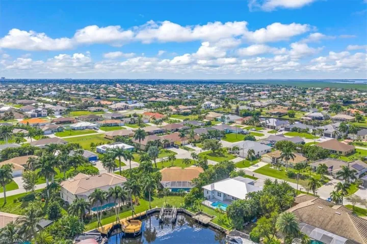 Aerial perspective of suburban area featuring a large body of water
