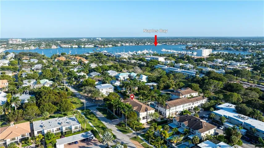 Aerial view of property and surrounding area with nearby suburban area and a large body of water