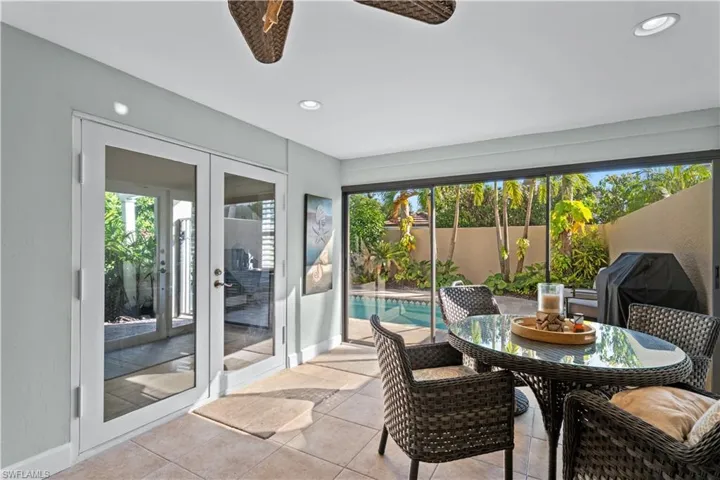 Sunroom / solarium featuring french doors and recessed lighting