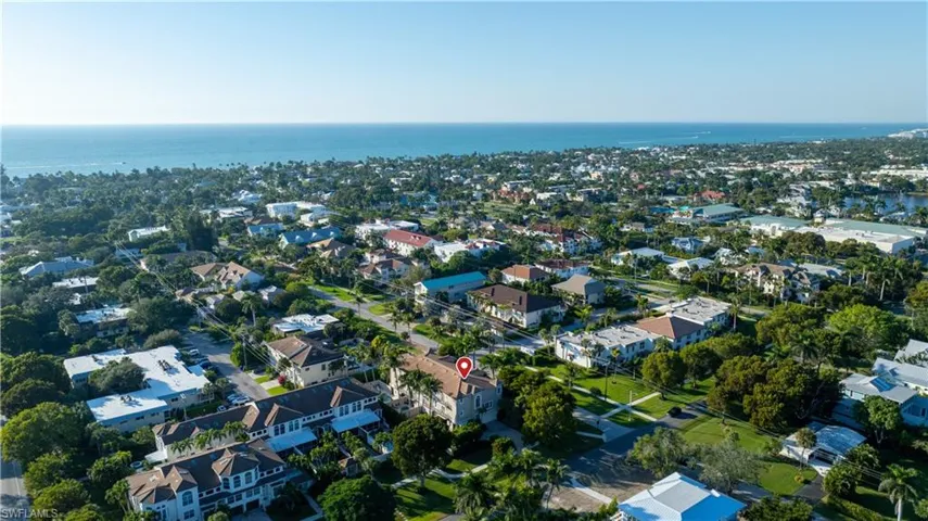 Aerial view of residential area featuring a large body of water