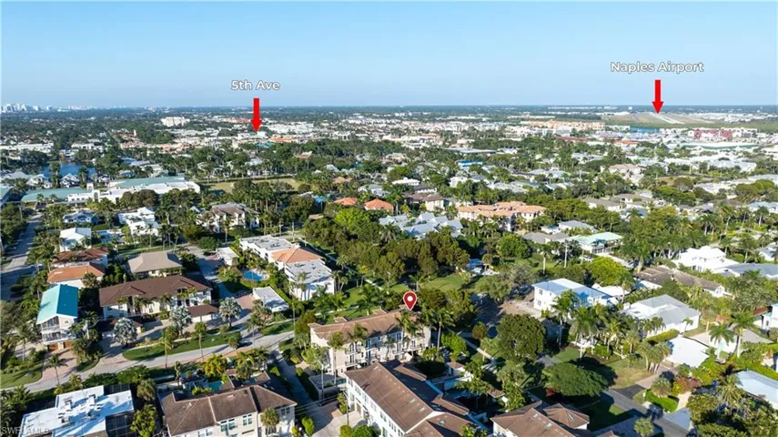 Aerial view of property and surrounding area with nearby suburban area
