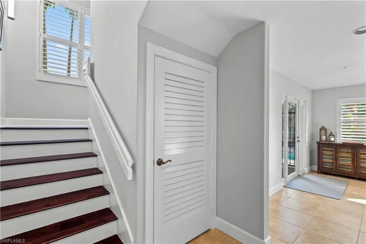 Stairs featuring tile patterned floors and baseboards