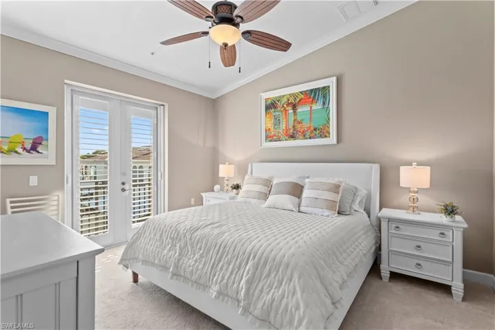 Bedroom featuring ornamental molding, light carpet, access to exterior, and ceiling fan
