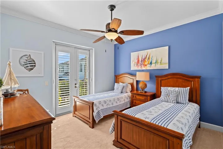 Bedroom featuring crown molding, access to outside, light colored carpet, and ceiling fan