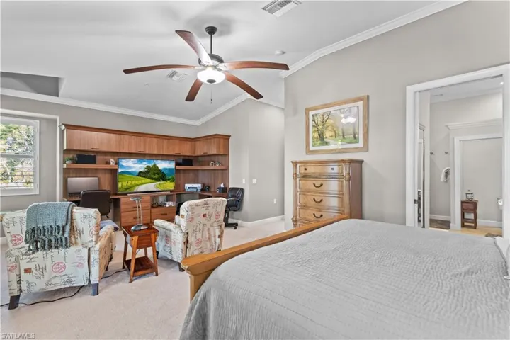 Bedroom with lofted ceiling, carpet, ornamental molding, and ceiling fan