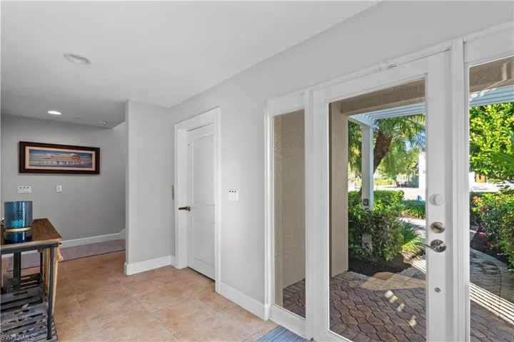 Doorway to outside with tile patterned floors and recessed lighting