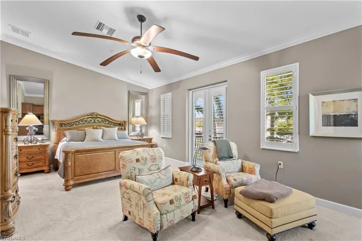 Carpeted bedroom with crown molding, ceiling fan, and access to outside