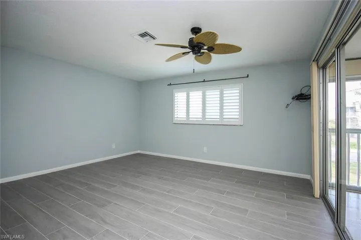 Spare room with plenty of natural light, baseboards, visible vents, and ceiling fan