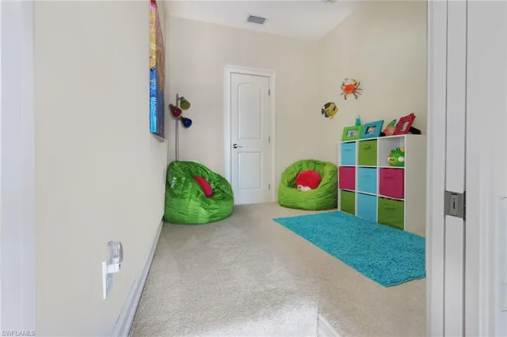 Rec room with carpet floors and visible vents