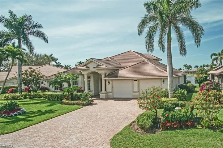 Mediterranean / spanish house featuring decorative driveway, stucco siding, an attached garage, a front yard, and a tiled roof