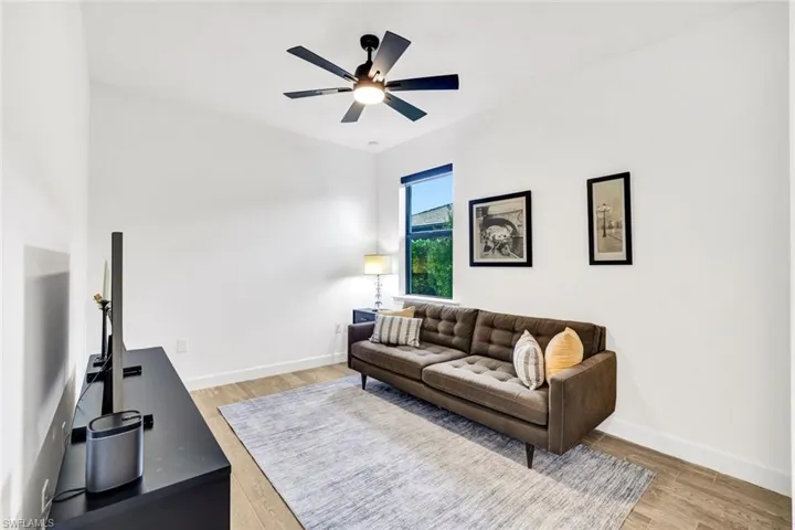 Bedroom with light tile flooring and a ceiling fan