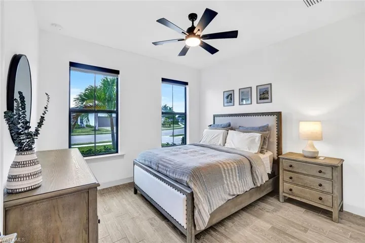 Bedroom with light tile flooring and a ceiling fan