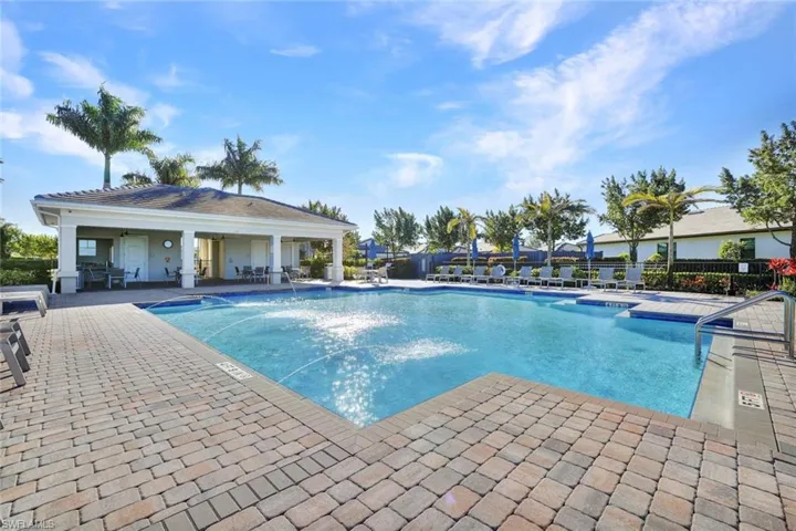 Community pool featuring a patio area and grilling space