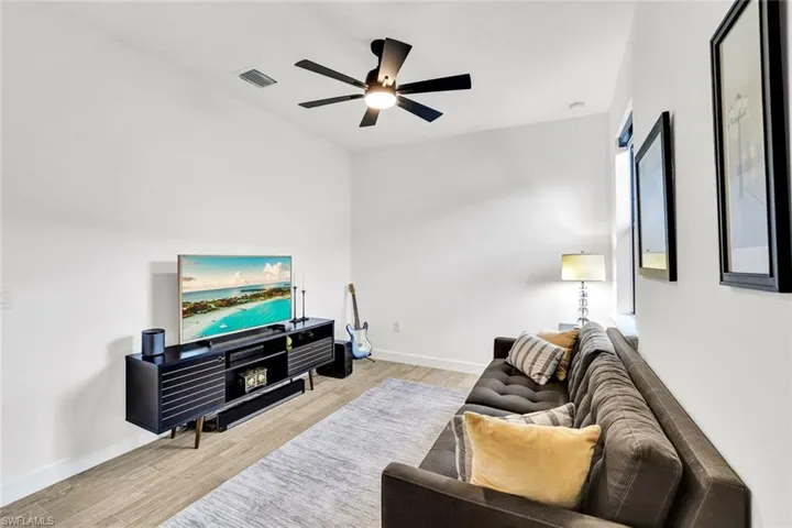 Bedroom with light tile flooring and a ceiling fan
