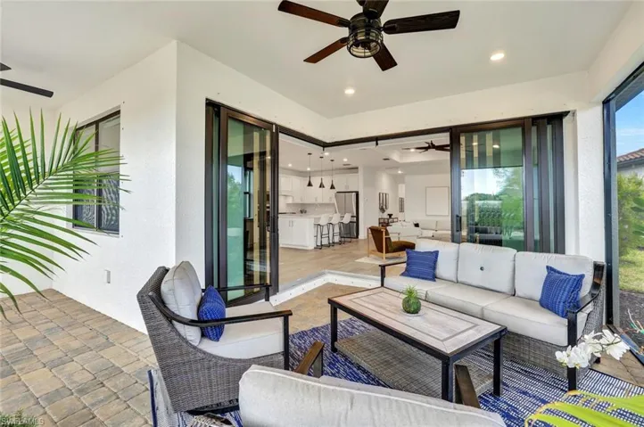 View of extended patio with ceiling fan, recessed lighting and outdoor furniture