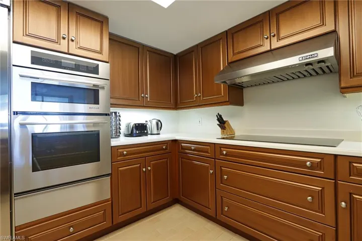 Kitchen featuring black electric stovetop and double oven