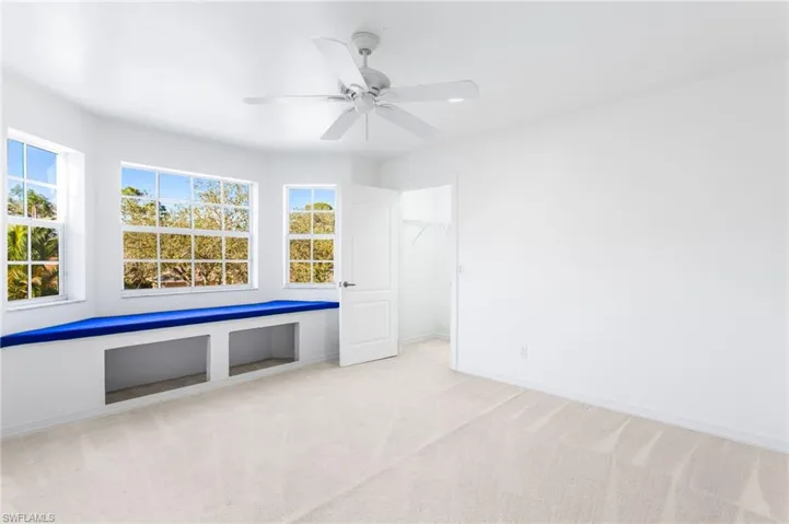 Bright room featuring a multi-pane window bay with a built-in window bench and storage cubbies