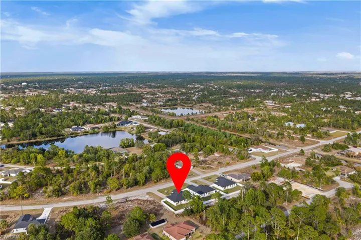 Aerial perspective of suburban area with a large body of water