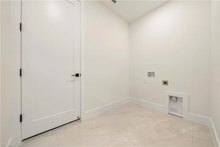 Laundry area with hookup for a washing machine, electric dryer hookup, and vaulted ceiling