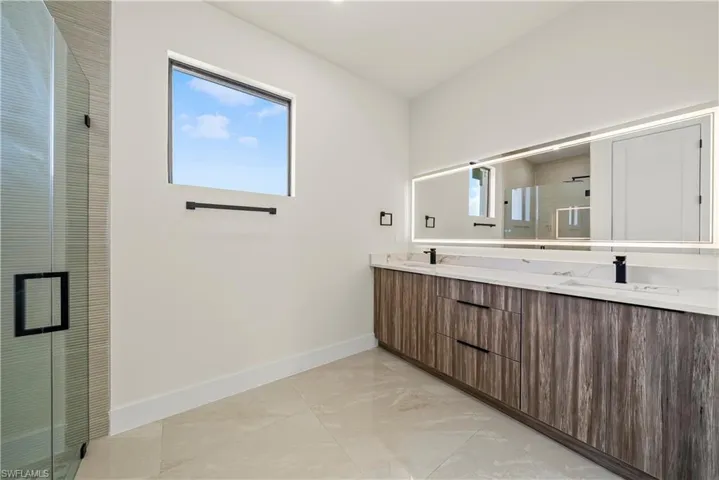Bathroom with a shower stall and double vanity