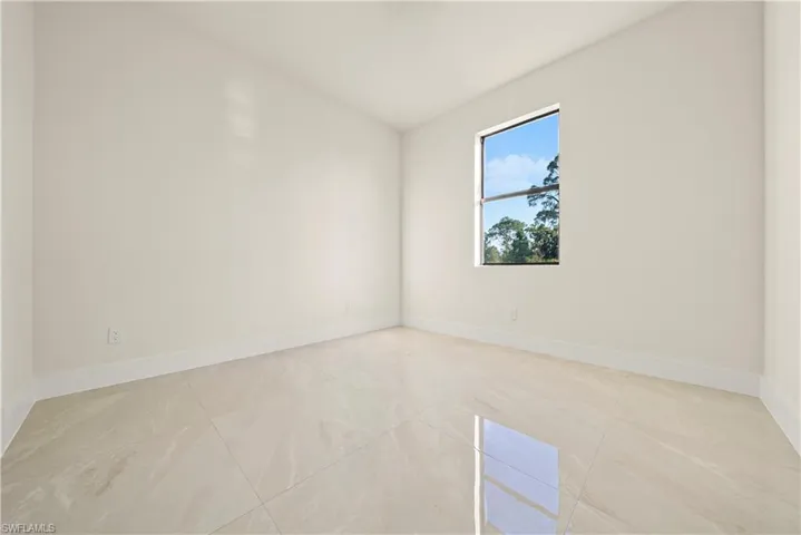 Unfurnished room featuring baseboards