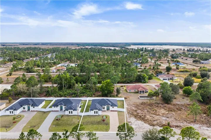 Aerial view of residential area featuring property boundaries highlighted