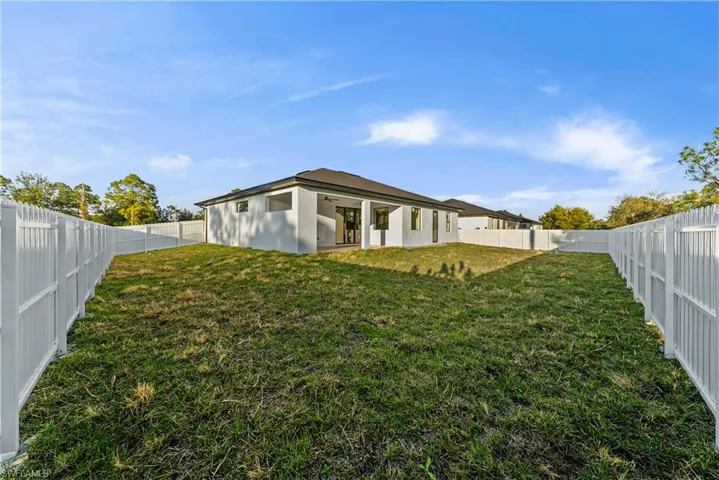 Back of property with a patio and a fenced backyard