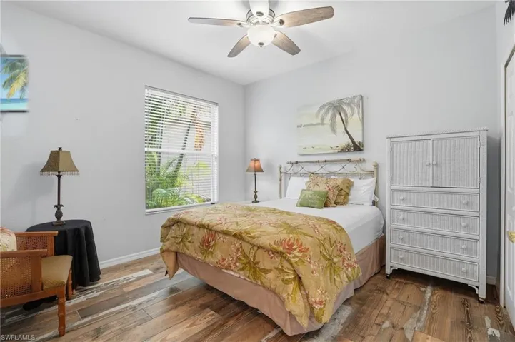 Bedroom featuring wood-type flooring and a ceiling fan