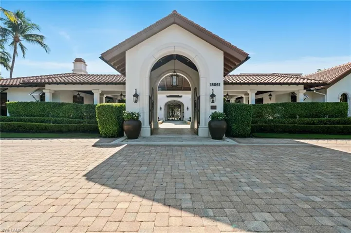 View of exterior entry featuring stucco siding and a chimney