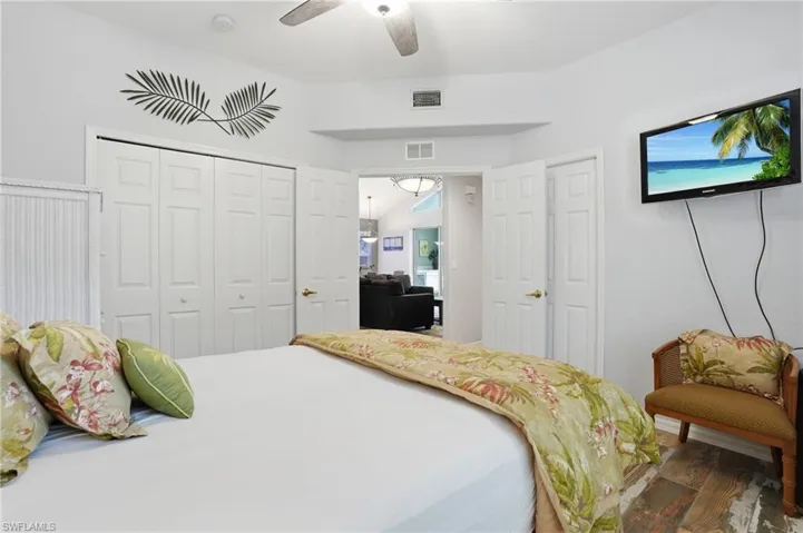 Bedroom featuring wood finished floors, a closet, and a ceiling fan