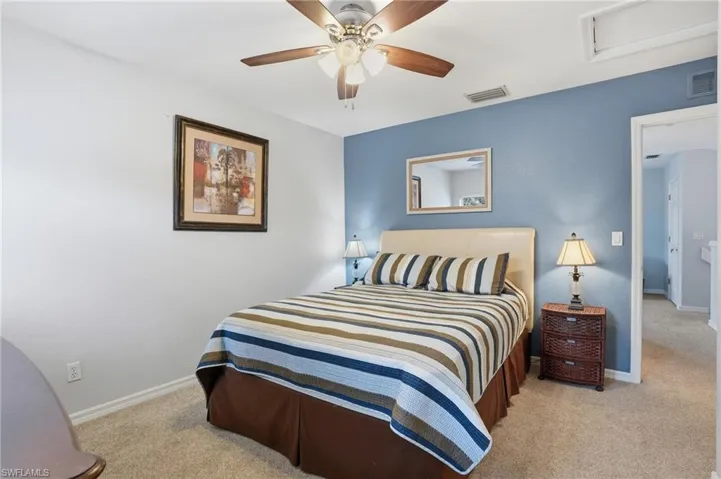 Bedroom featuring light carpet and ceiling fan