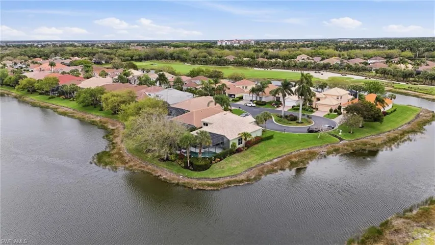 Aerial perspective of suburban area featuring a large body of water