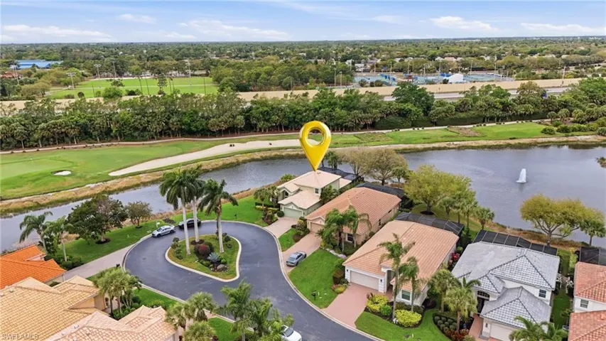 Aerial view of residential area with a large body of water and a golf course