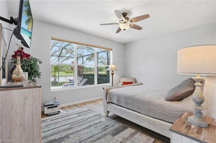 Bedroom with ceiling fan and light wood-style floors