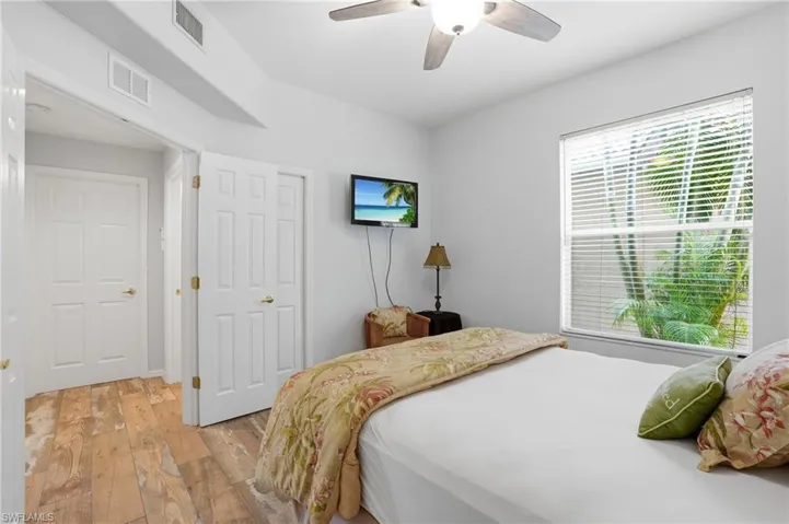 Bedroom with light wood-style floors and a ceiling fan