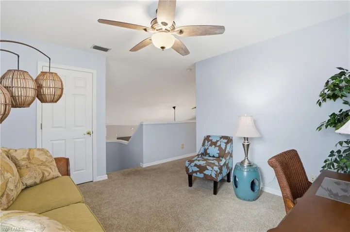 Office space with ceiling fan and carpet