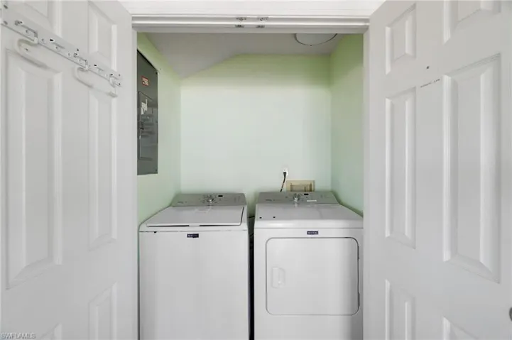 Dedicated laundry closet with bi-fold panel doors - Virtually Edited Image