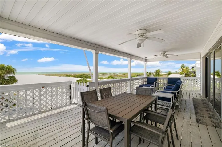 Covered outdoor deck with white painted wood flooring and ceiling - Virtually Edited Image