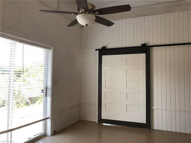 Lots of light and barn door in bedroom separates bedroom from living area