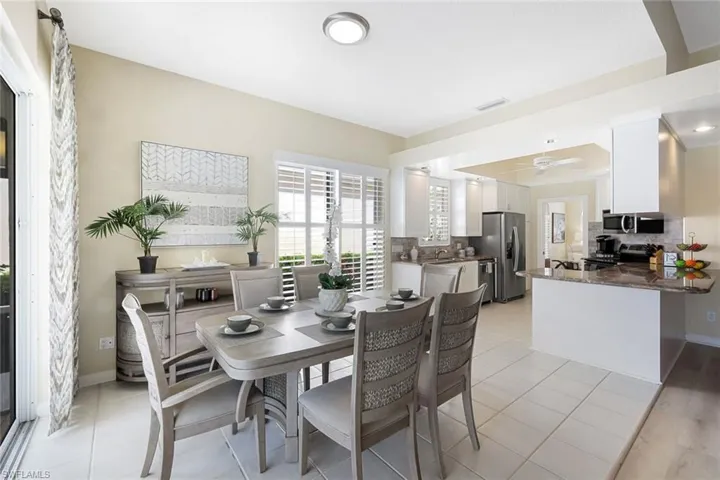 Indoor dining exhibits large table w/matching buffet table (included if desired! ) Double glass sliders open to side yard w/ cement walkway leading to front and back of home.