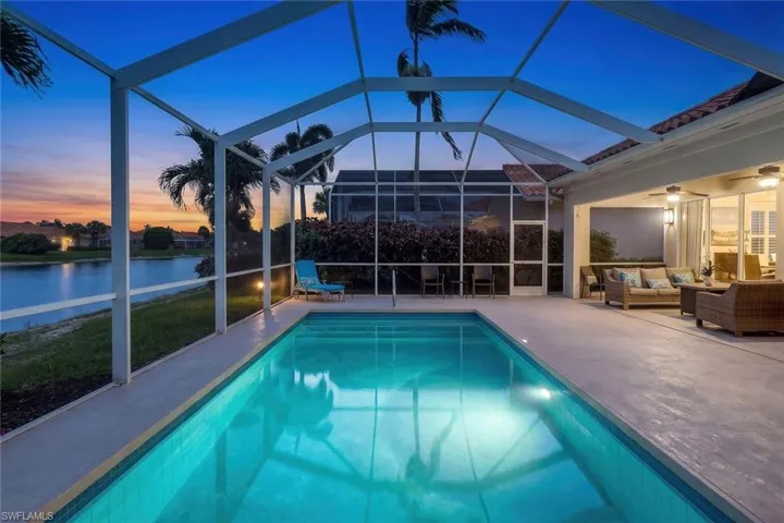 Residence large lap pool, large deck & covered lanai w/qualiy furniture included! Wide lake w/sunset views! Dreamy!