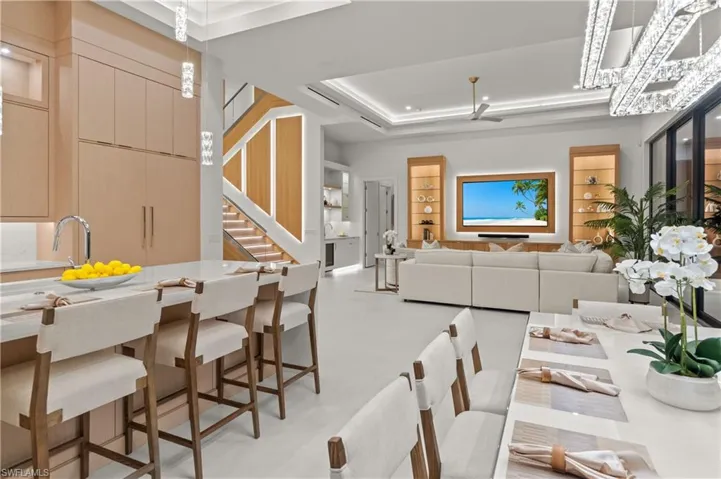Dining room featuring a raised ceiling and stairway
