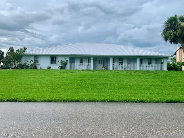 Single story home featuring a front lawn