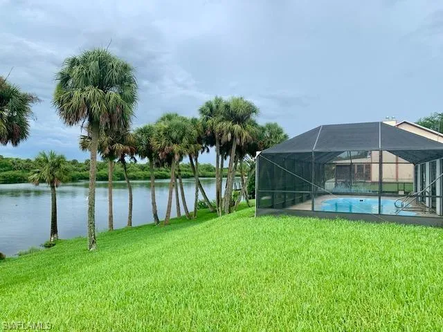 View of yard featuring a lanai and a water view