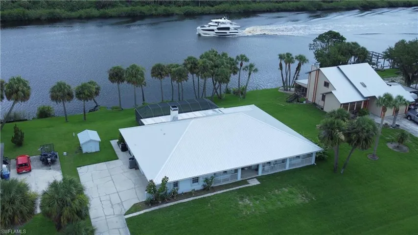 Birds eye view of property with a water view